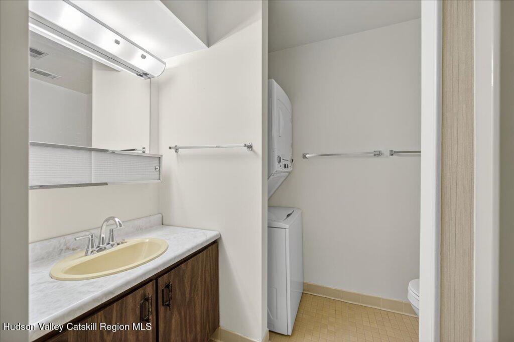 6 Knights Bridge, Unit B Poughkeepsie, NY 12603 - Photo 7 of 20 a bathroom with a granite countertop sink and a mirror