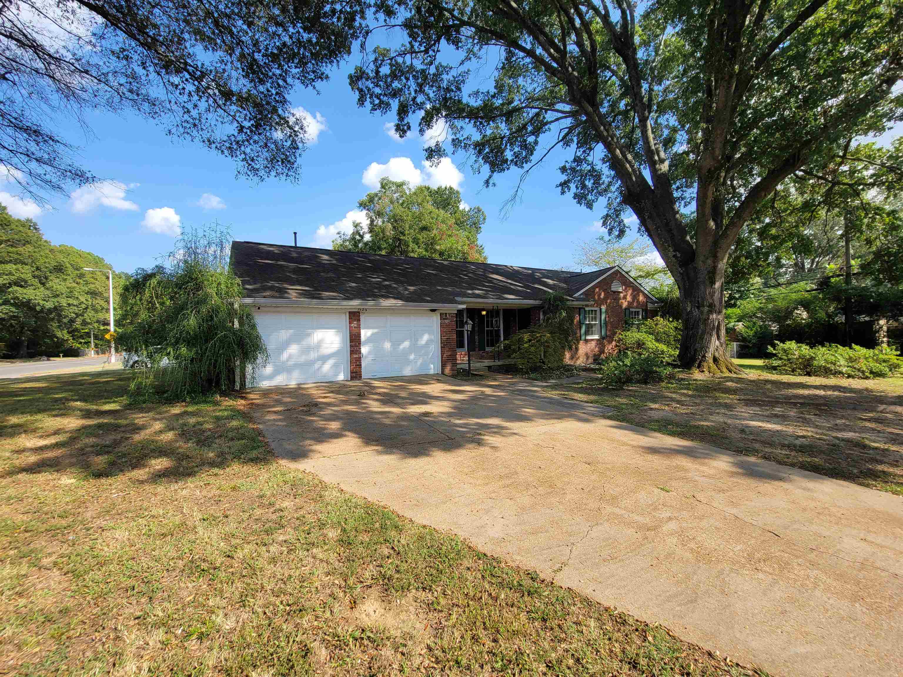 1522 Hayne Road Memphis, TN 38119 - Photo 1 of 25 a front view of a house with a yard and a garage