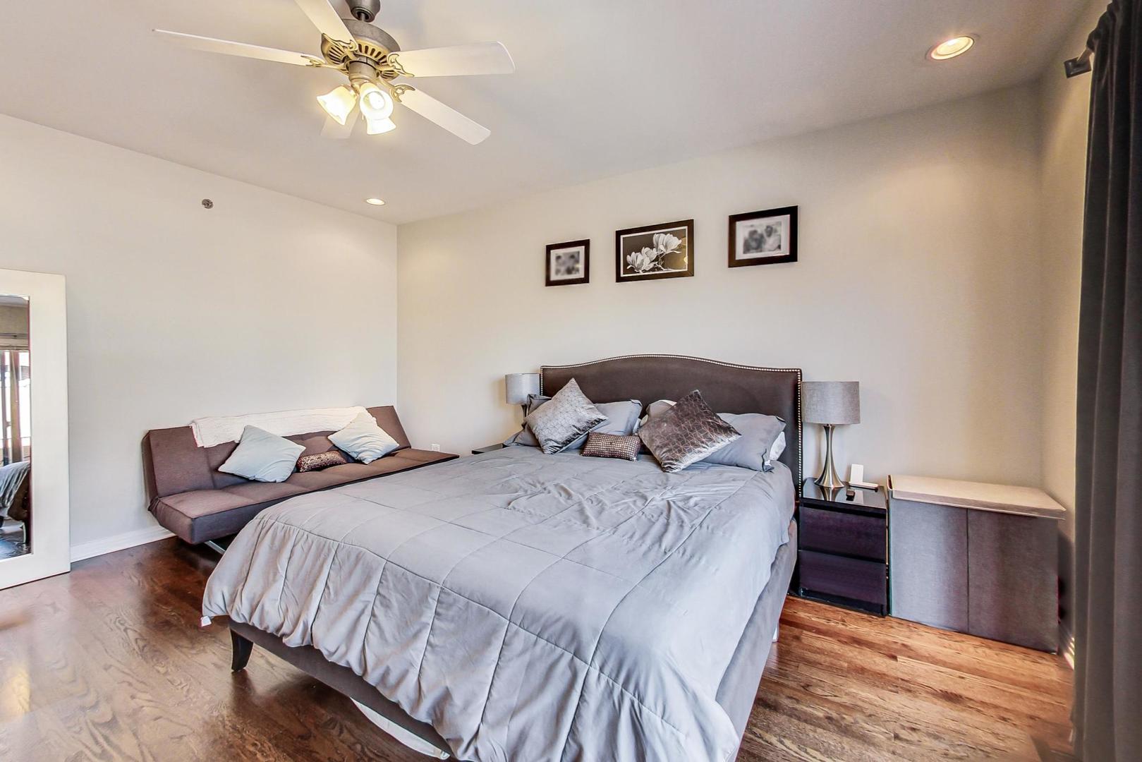 1137 West Monroe Street Chicago, IL 60607 - Photo 15 of 33 a bedroom with bed and a chandelier