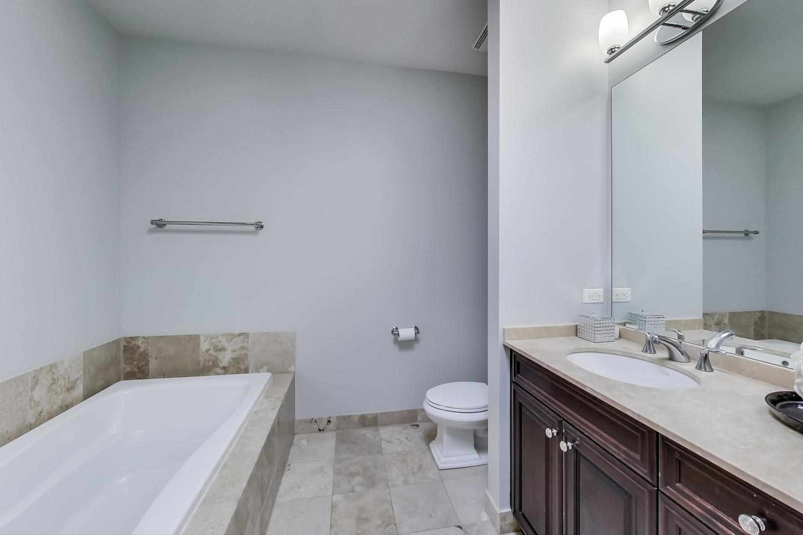 1137 West Monroe Street Chicago, IL 60607 - Photo 17 of 33 a bathroom with a sink a toilet and bathtub