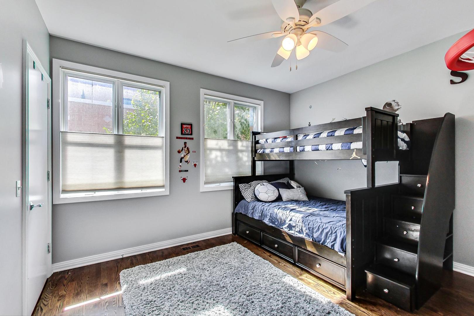 1137 West Monroe Street Chicago, IL 60607 - Photo 19 of 33 a bedroom with a bed and wooden floor