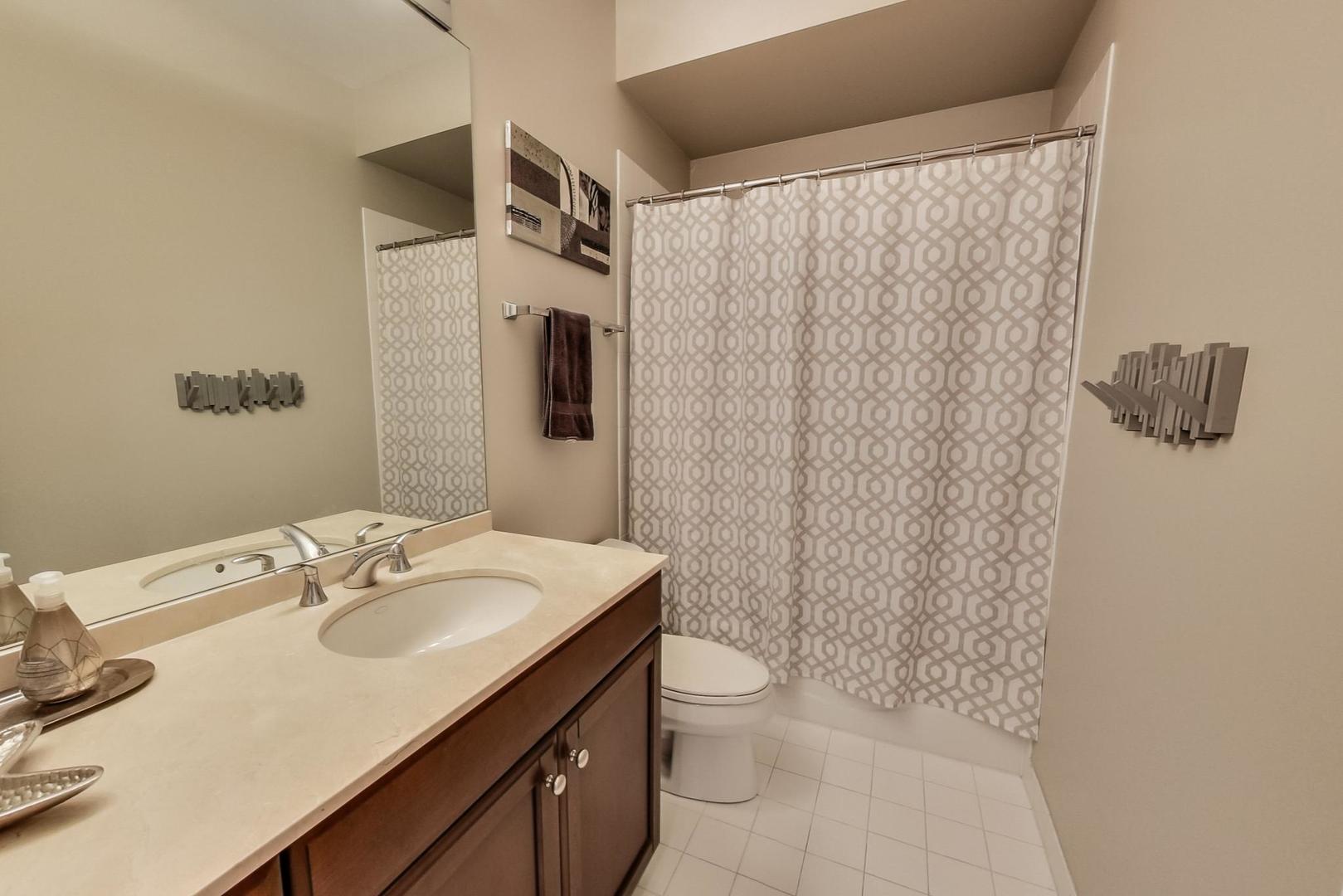 1137 West Monroe Street Chicago, IL 60607 - Photo 20 of 33 a bathroom with a sink toilet and shower