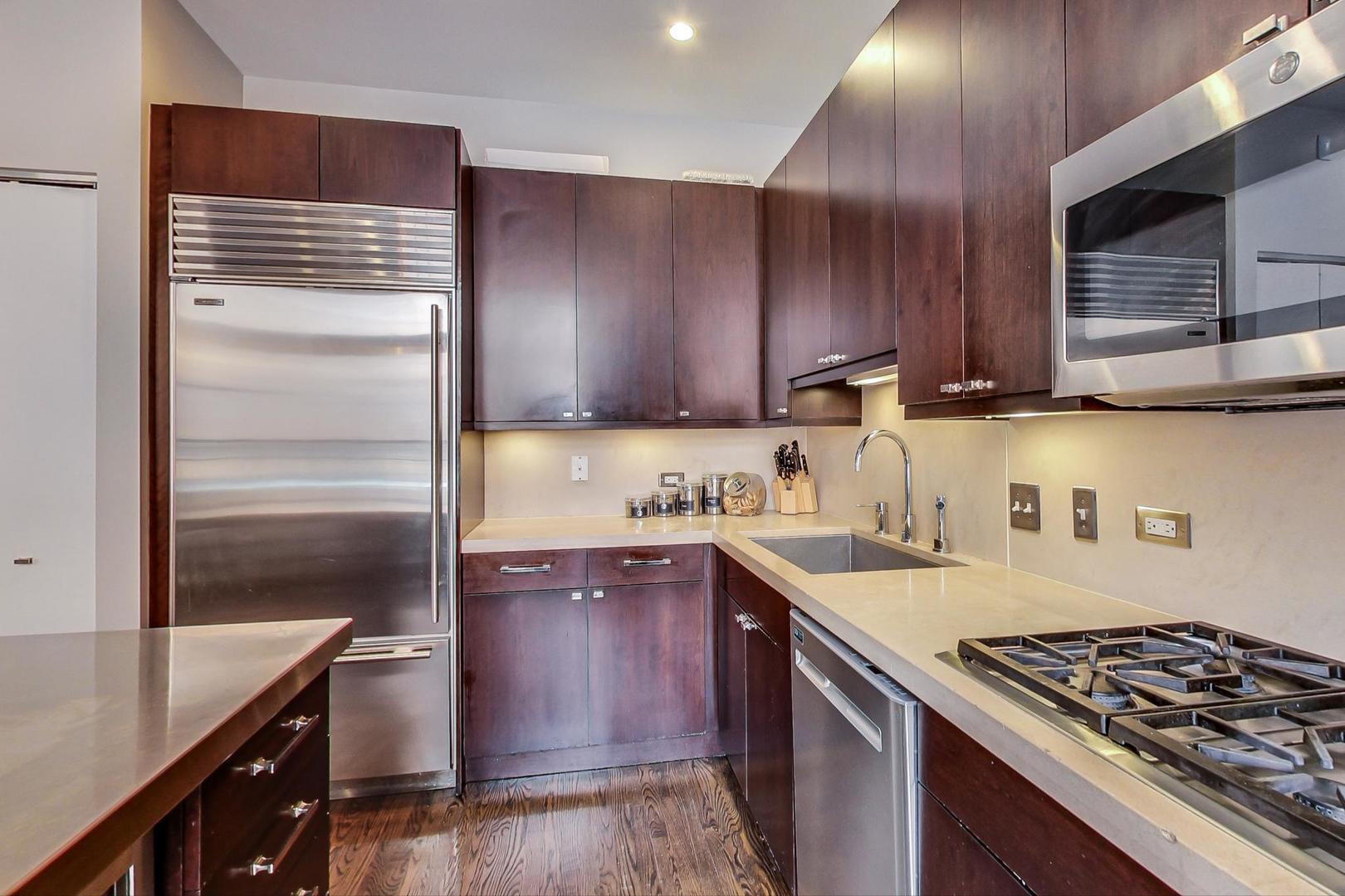 1137 West Monroe Street Chicago, IL 60607 - Photo 10 of 33 a kitchen with a sink stove and cabinets