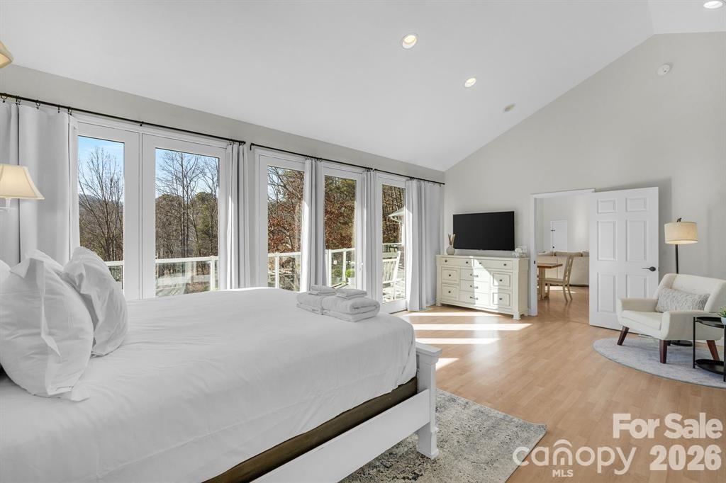 56 Great Horned Owl Road Candler, NC 28715 - Photo 16 of 32 a large bedroom with a bed and a large window