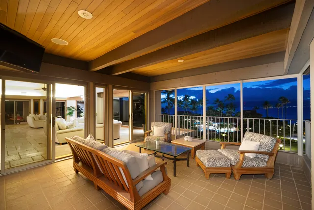 a living room with furniture a dining table and chairs with the large windows