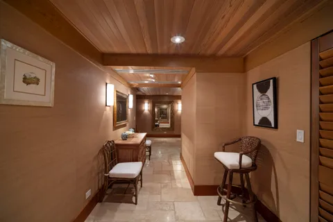 a hallway with furniture and a potted plant