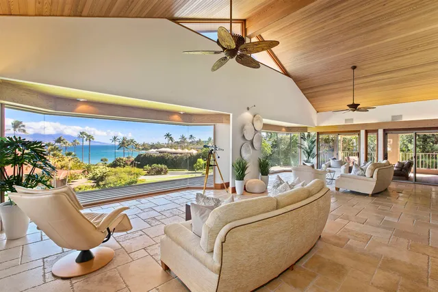 a room with stainless steel appliances kitchen island granite countertop a sink and cabinets