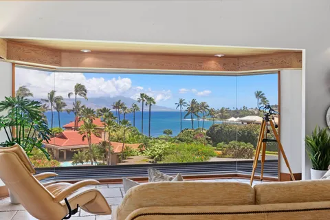 a room with painting on the wall and a potted plant