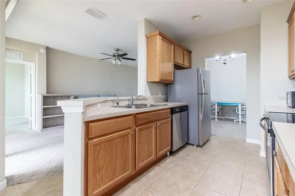 a kitchen with stainless steel appliances granite countertop cabinets and a stove top oven