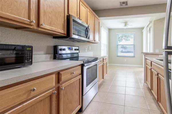 a kitchen with stainless steel appliances granite countertop a sink and a stove
