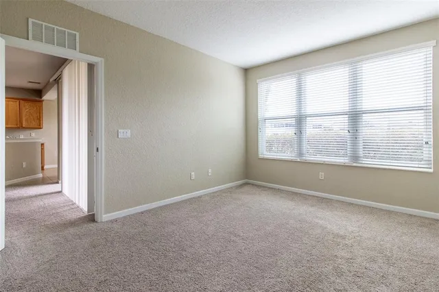 an empty room with an entryway and fire place