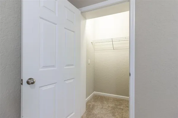 a view of a hallway with closet area