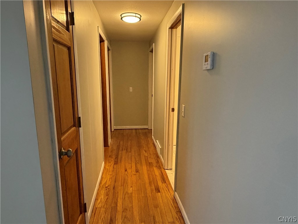 8587 Caughdenoy Road Clay, NY 13041 - Photo 9 of 21 Hallway to the bedrooms