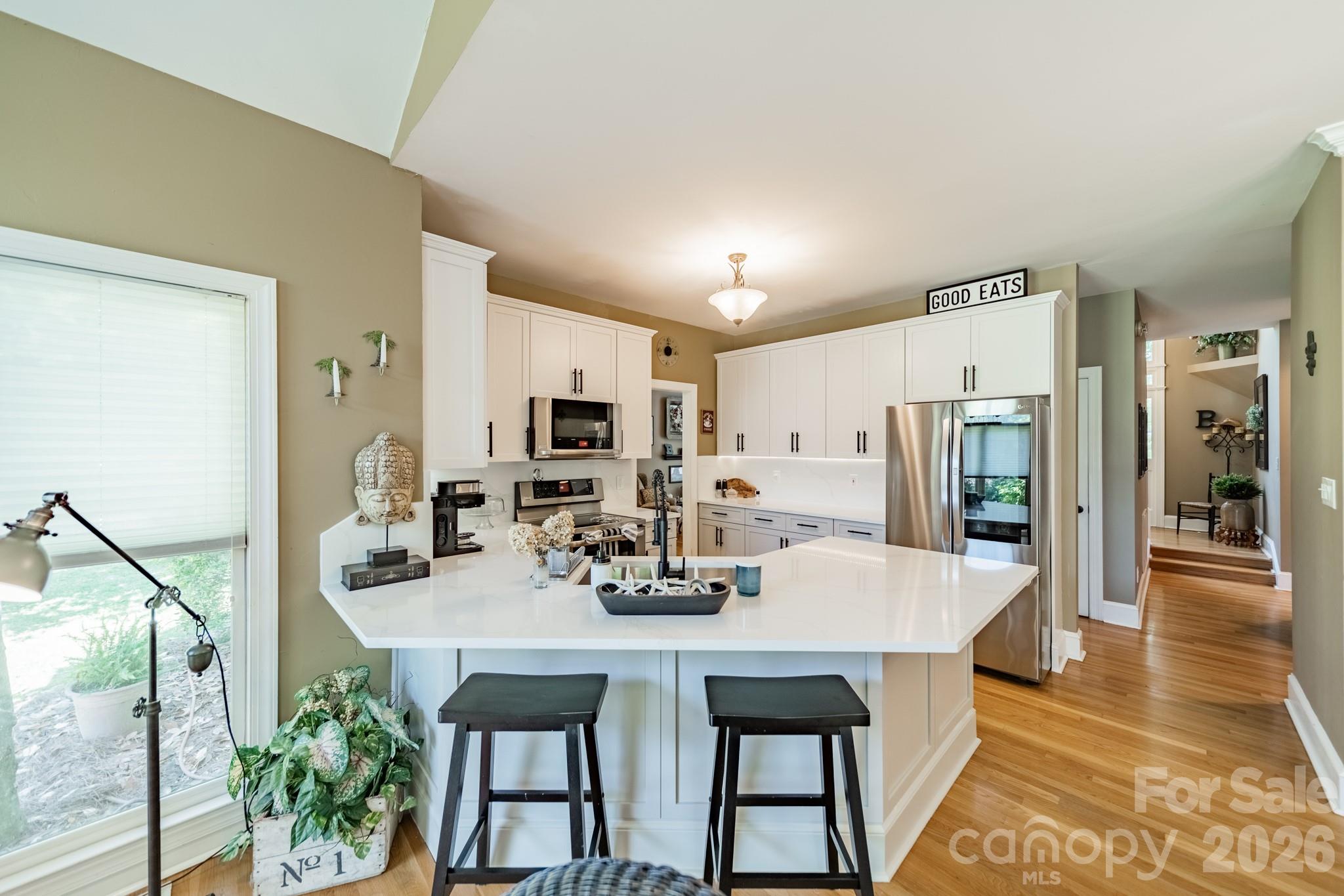 11043 Seven Coves Drive Tega Cay, SC 29708 - Photo 24 of 45 a view of a dining room with furniture and wooden floor