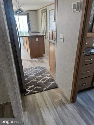 a view of a kitchen from a hallway