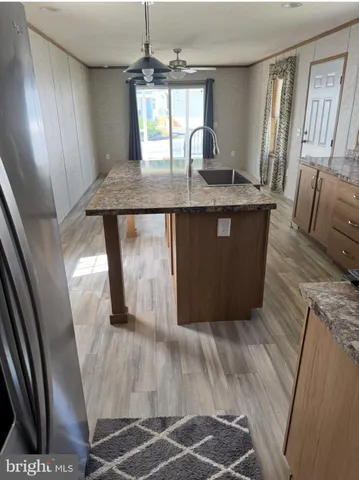 a room with wooden floor and glass windows