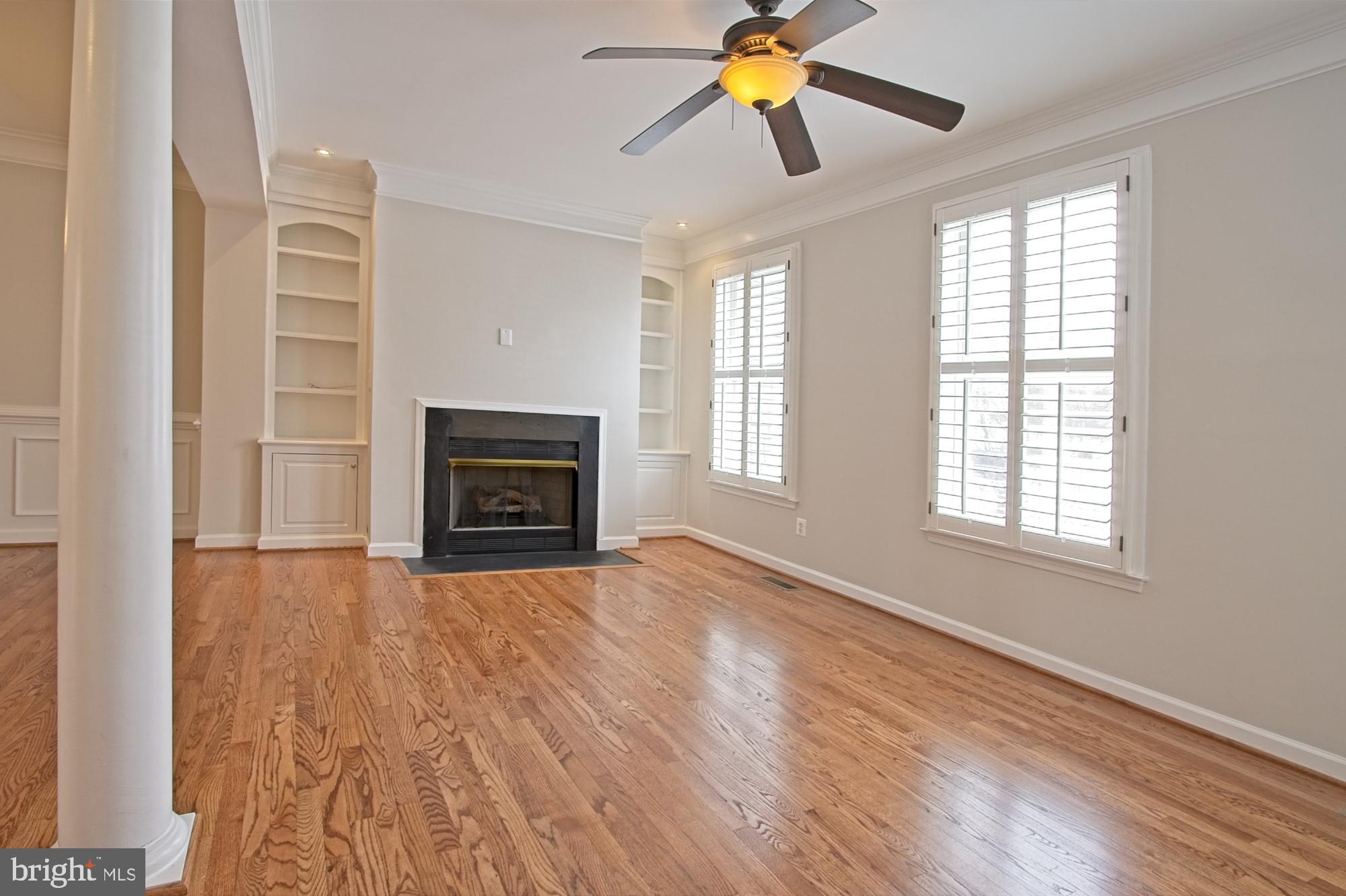 11117 Little Compton Drive Reston, VA 20191 - Photo 19 of 58 A gas fireplace is surrounded by custom cabinetry
