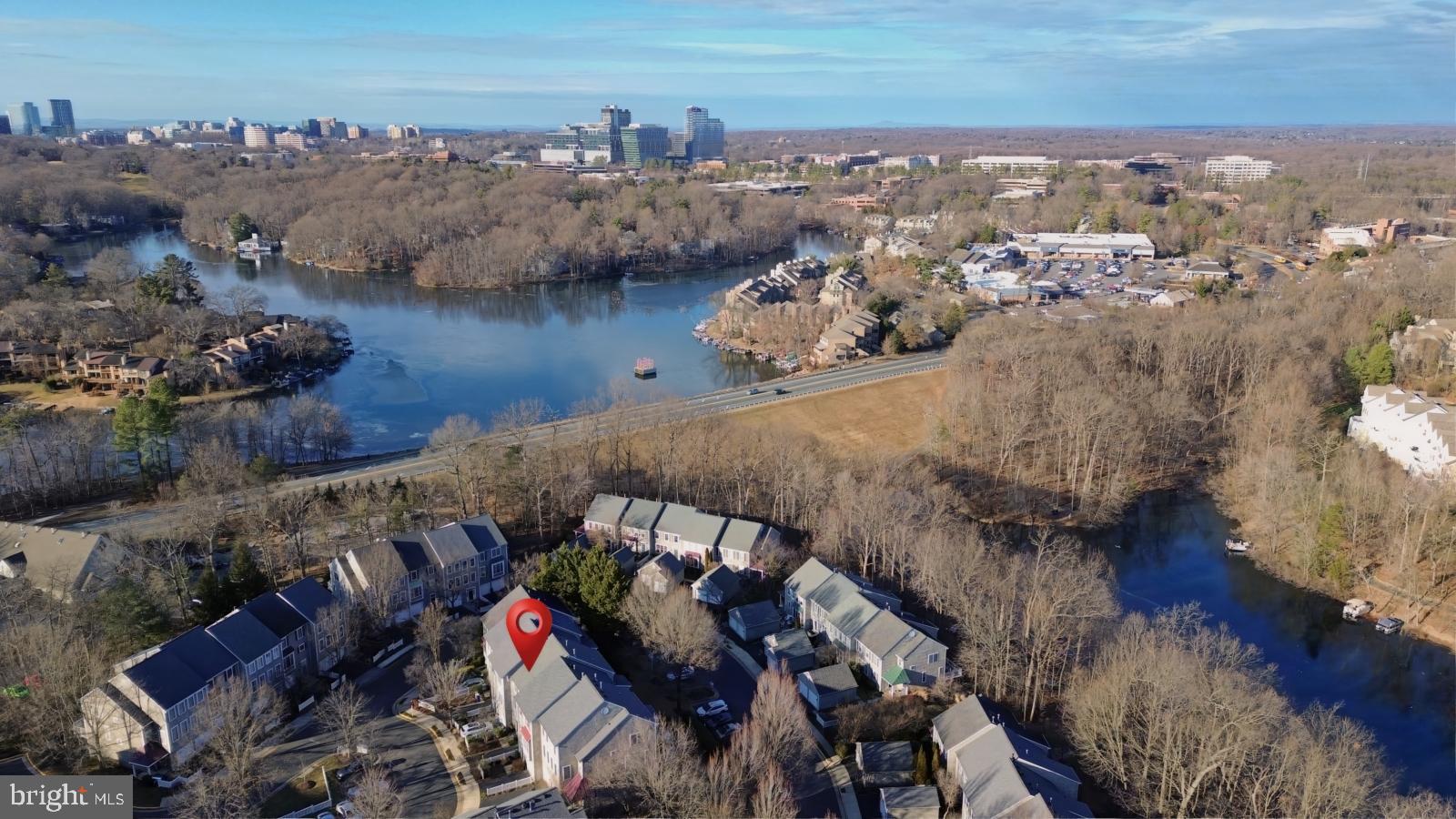 11117 Little Compton Drive Reston, VA 20191 - Photo 47 of 58 Scenic lakeside community with urban skyline.