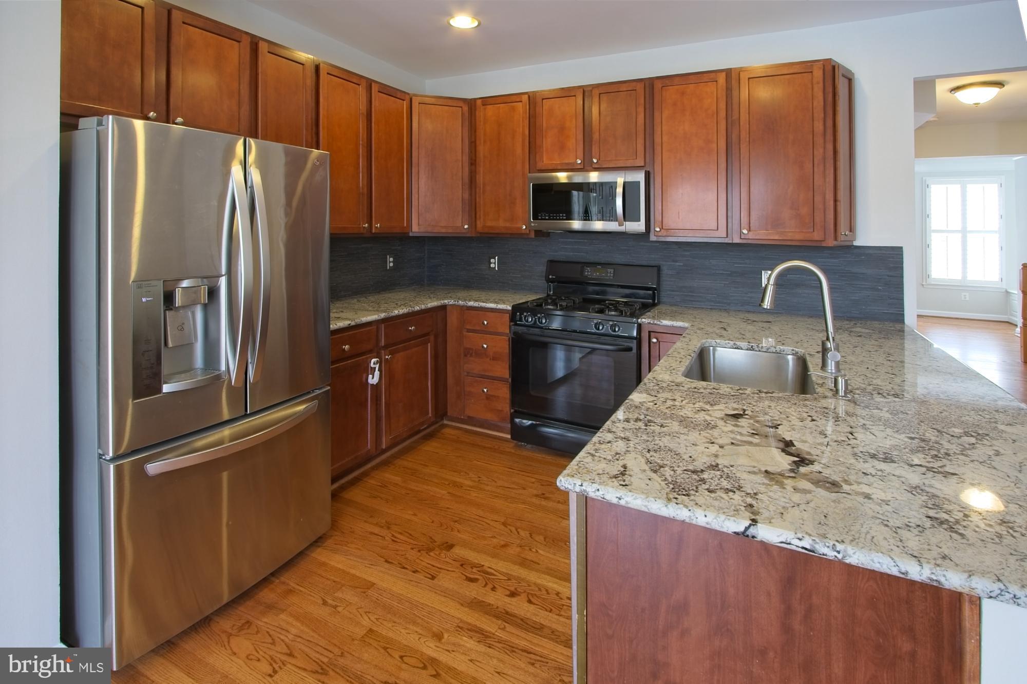 11117 Little Compton Drive Reston, VA 20191 - Photo 6 of 58 Stainless refrigerator, dishwasher and microwave