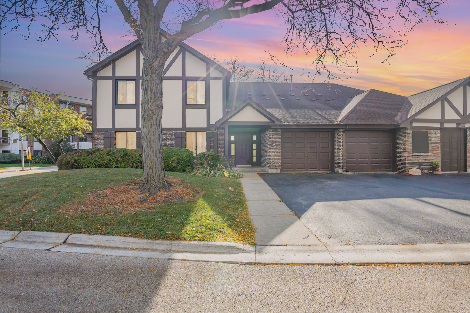 1054 Harbour Court, Unit 1A Wheeling, IL 60090 - Photo 1 of 1 front view of house with a yard