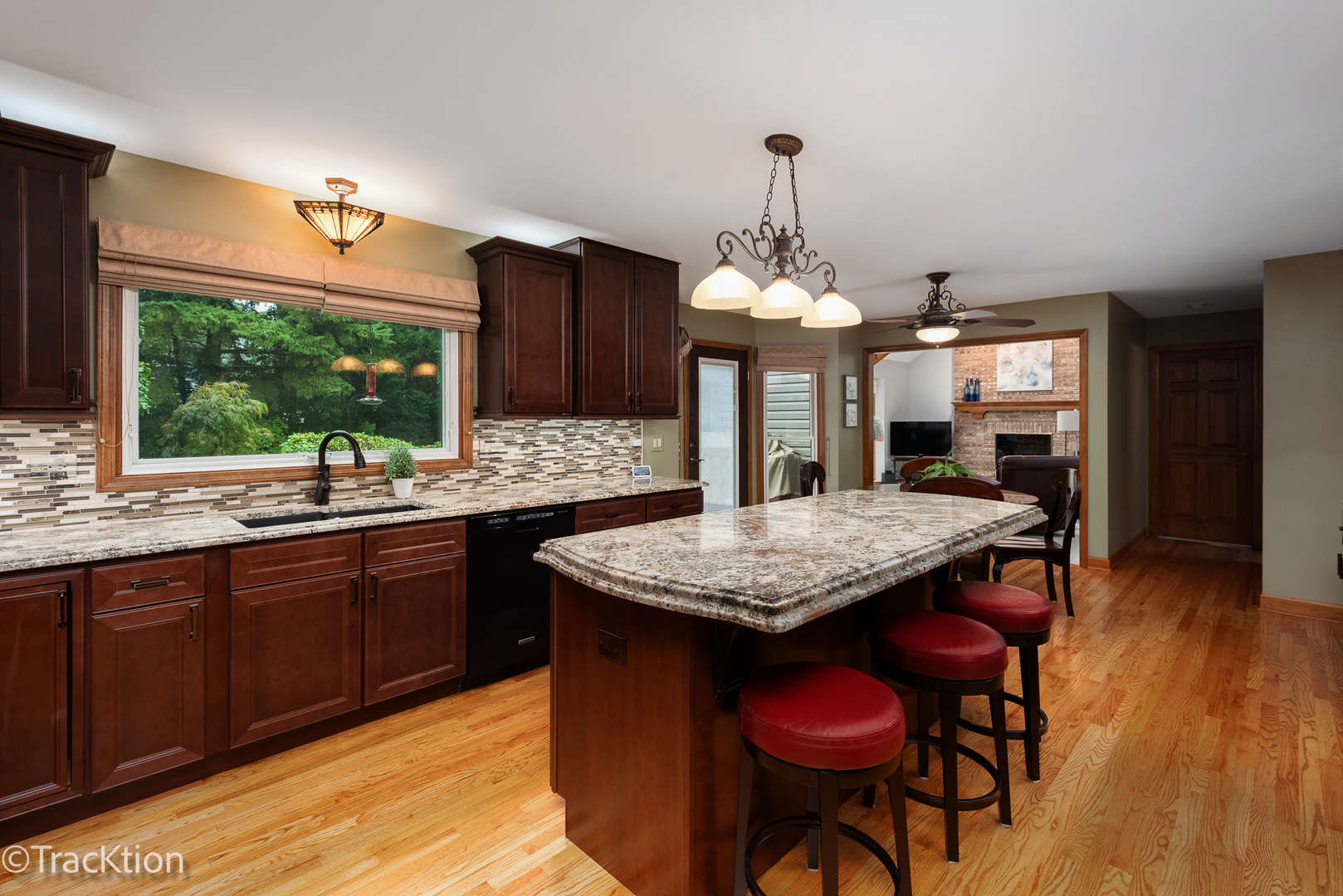 1740 Mundelein Road Naperville, IL 60565 - Photo 7 of 32 a kitchen with stainless steel appliances granite countertop wooden floors wooden cabinets a dining table and chairs