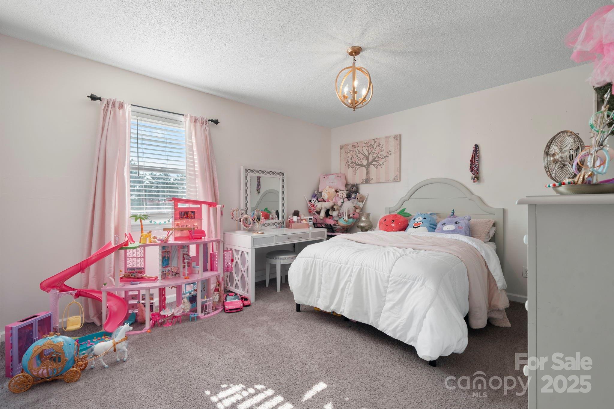 20 Meandering Way Granite Falls, NC 28630 - Photo 31 of 39 a bedroom with a bed and a chandelier