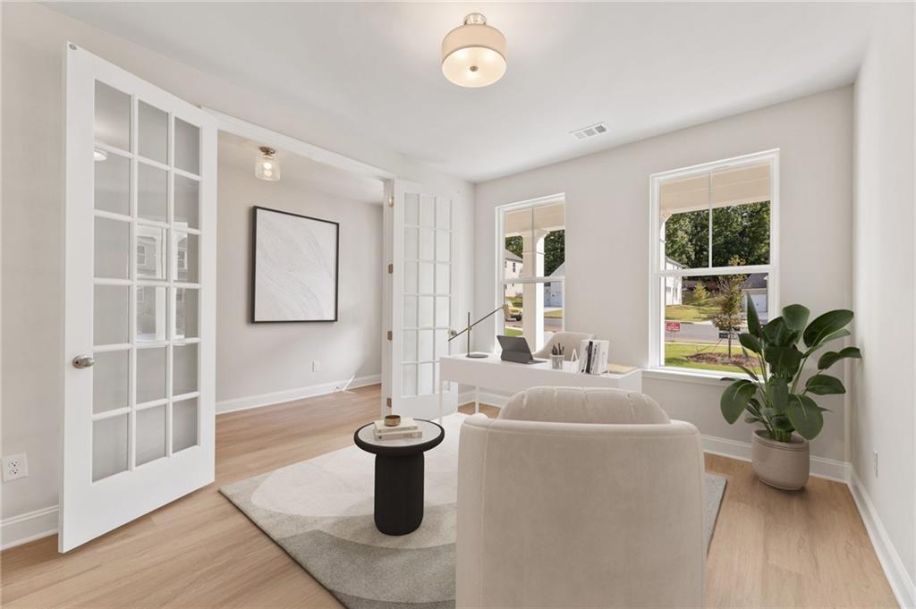 6944 Melody Ridge Road Buford, GA 30518 - Photo 3 of 24 a living room with furniture a window and a potted plant