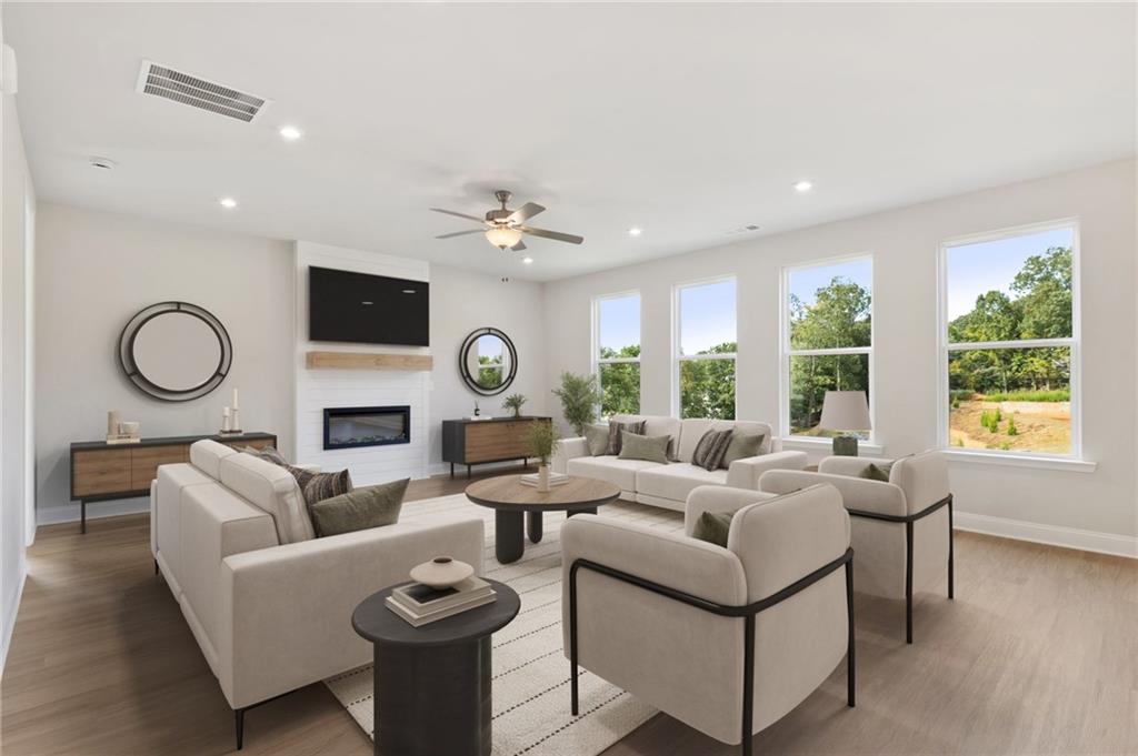 6944 Melody Ridge Road Buford, GA 30518 - Photo 4 of 24 a living room with furniture a fireplace and a large window
