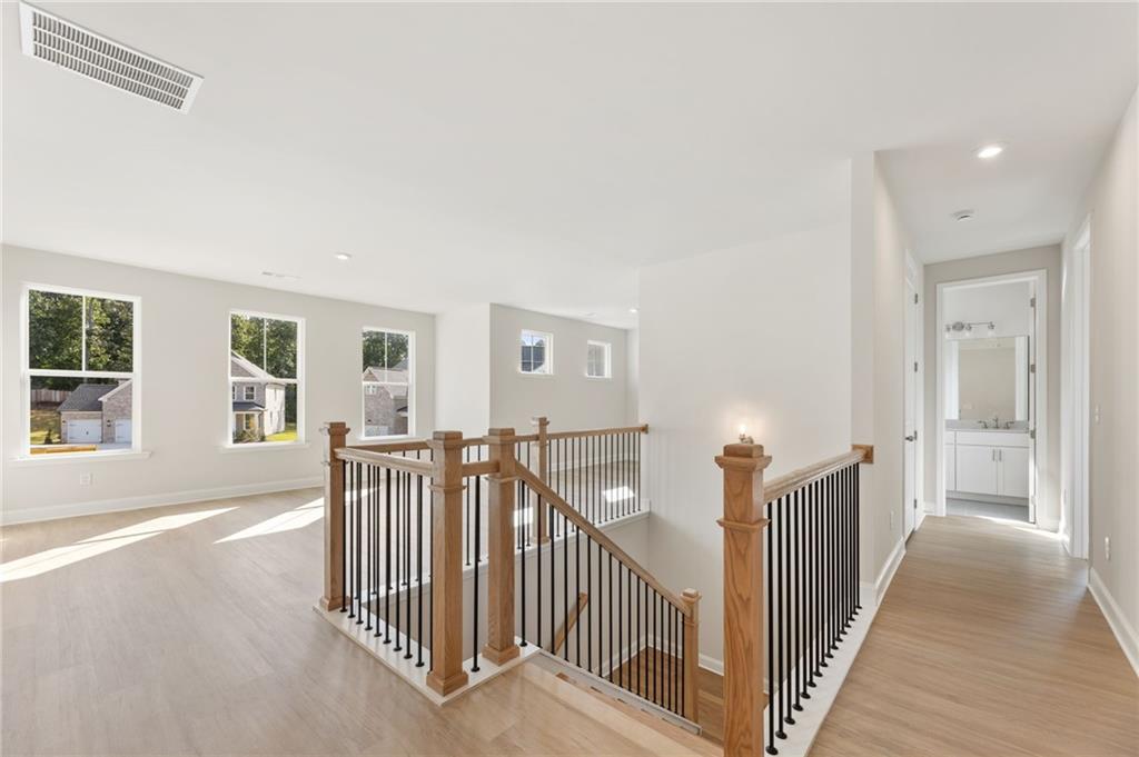 6944 Melody Ridge Road Buford, GA 30518 - Photo 10 of 24 a view of a room with wooden floor and windows