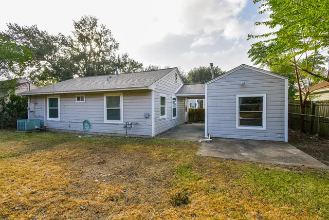 a view of a house with a large window and a yard