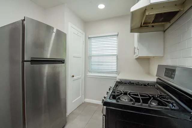 a kitchen with a stove and a refrigerator