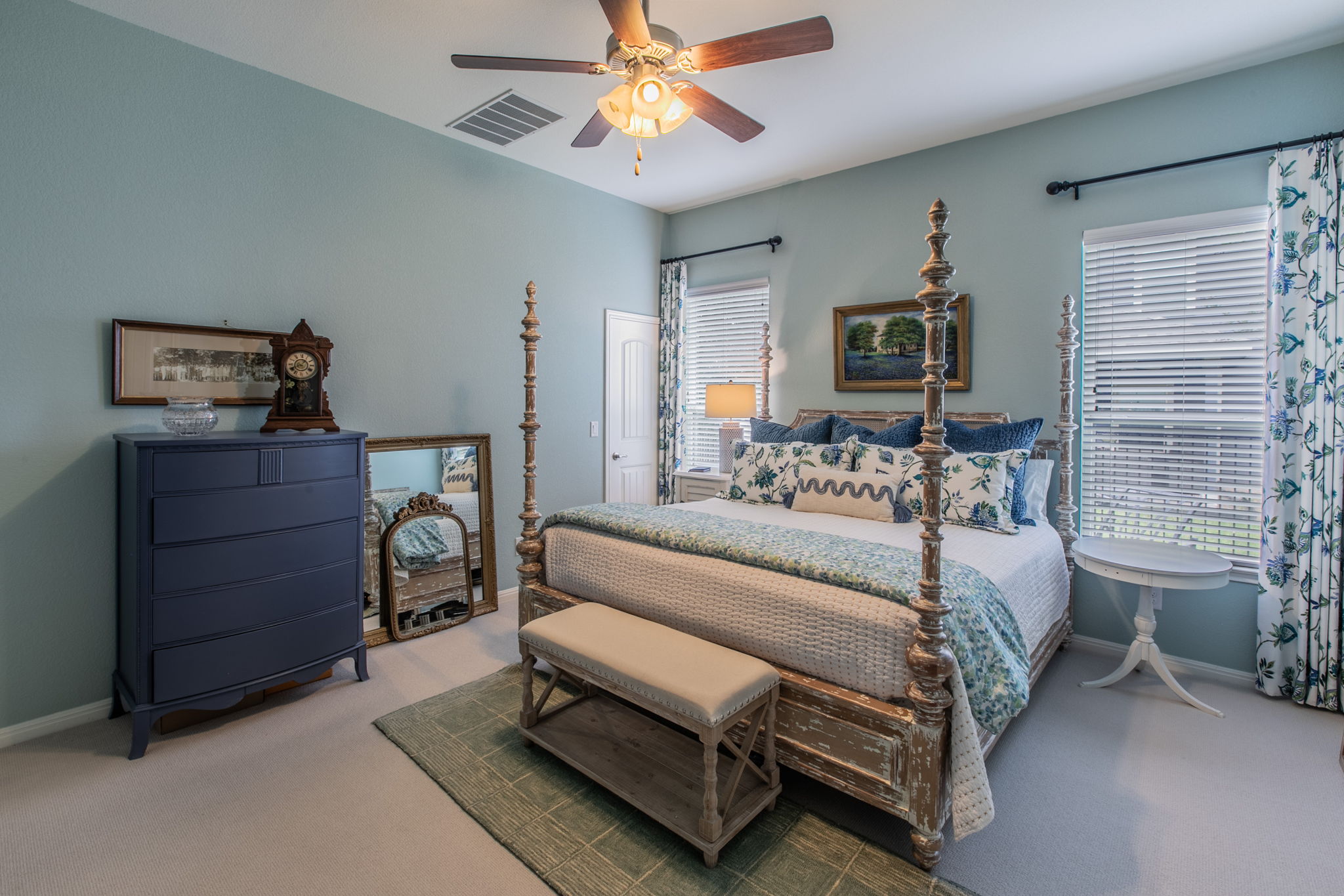 231 Simon Kyle, TX 78640 - Photo 13 of 29 Carpeted bedroom featuring two large windows with blinds, a ceiling fan with integrated lighting, and light blue walls