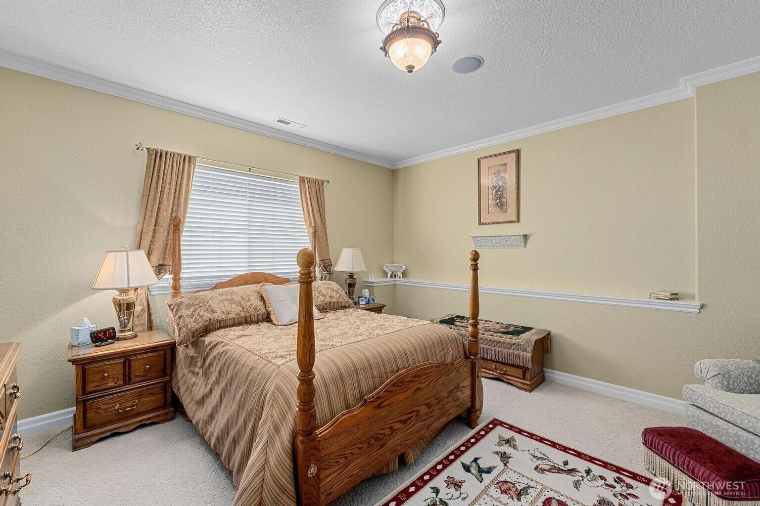 1650 East Fairway Loop Road Colville, WA 99114 - Photo 13 of 30 a bedroom with a bed and a chandelier