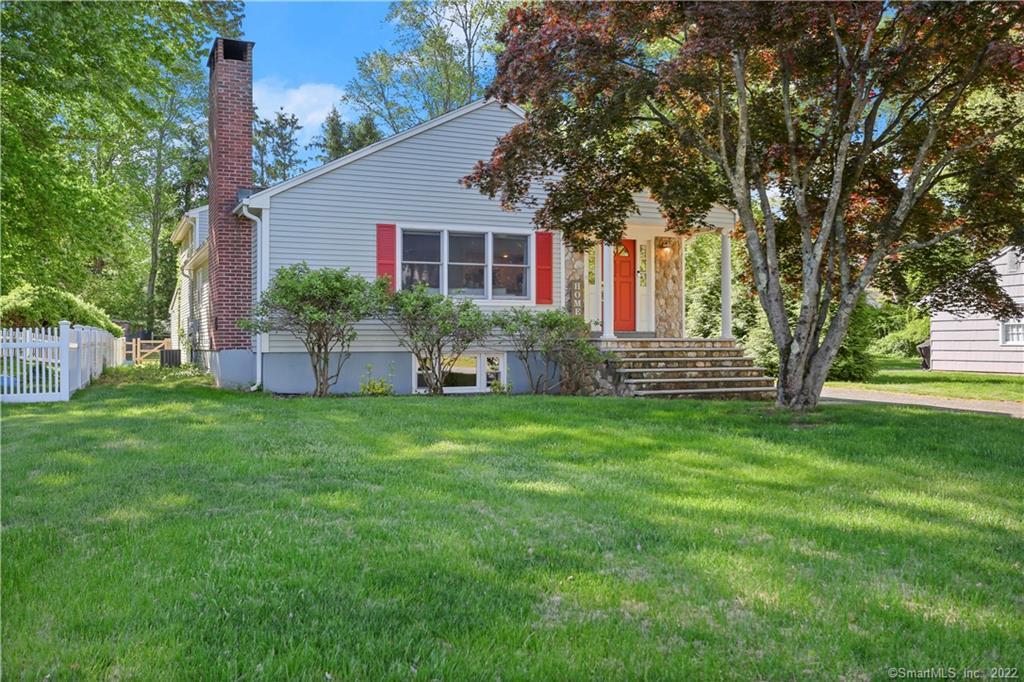 a front view of house with yard and green space