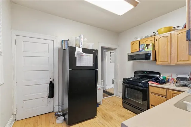 a kitchen with a refrigerator stove and sink