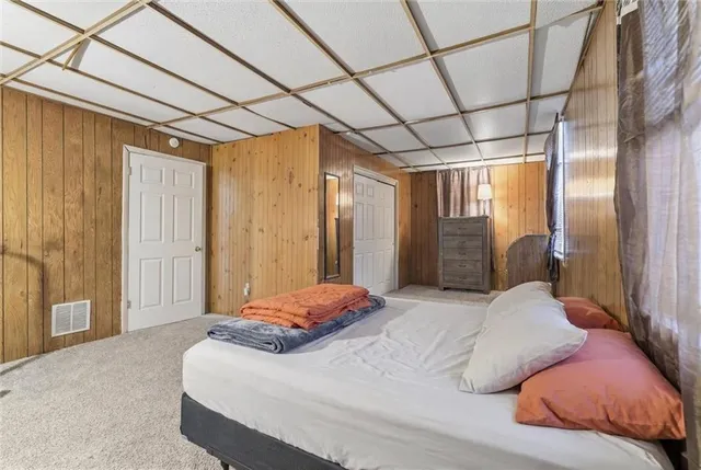 a bedroom with a large bed and a large window