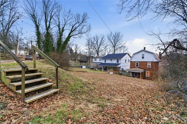 a view of a brick house with many windows
