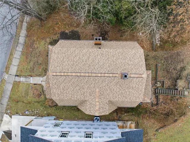a view of a house with backyard and sitting area