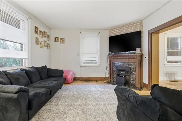 a living room with furniture a flat screen tv and a fireplace