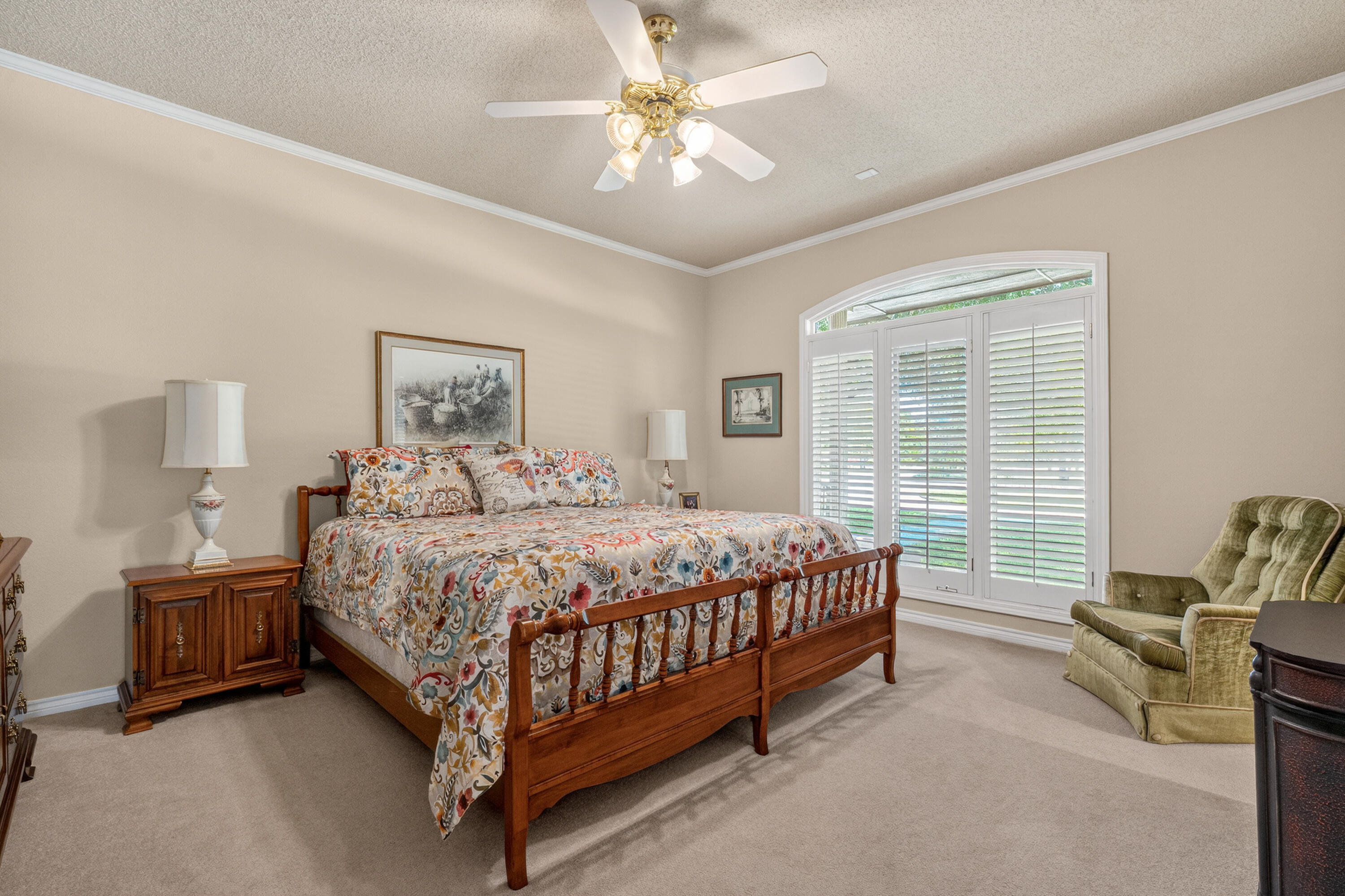 7402 95th Street Lubbock, TX 79424 - Photo 31 of 43 a bedroom with a bed and a chandelier