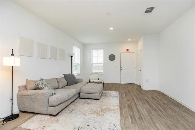 a living room with furniture and a lamp