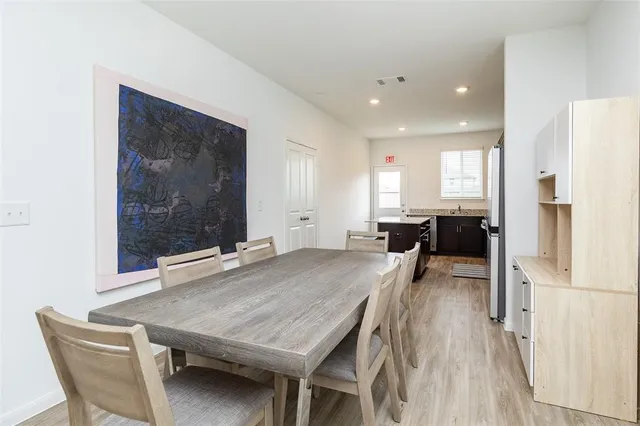 a dining room with furniture and a refrigerator