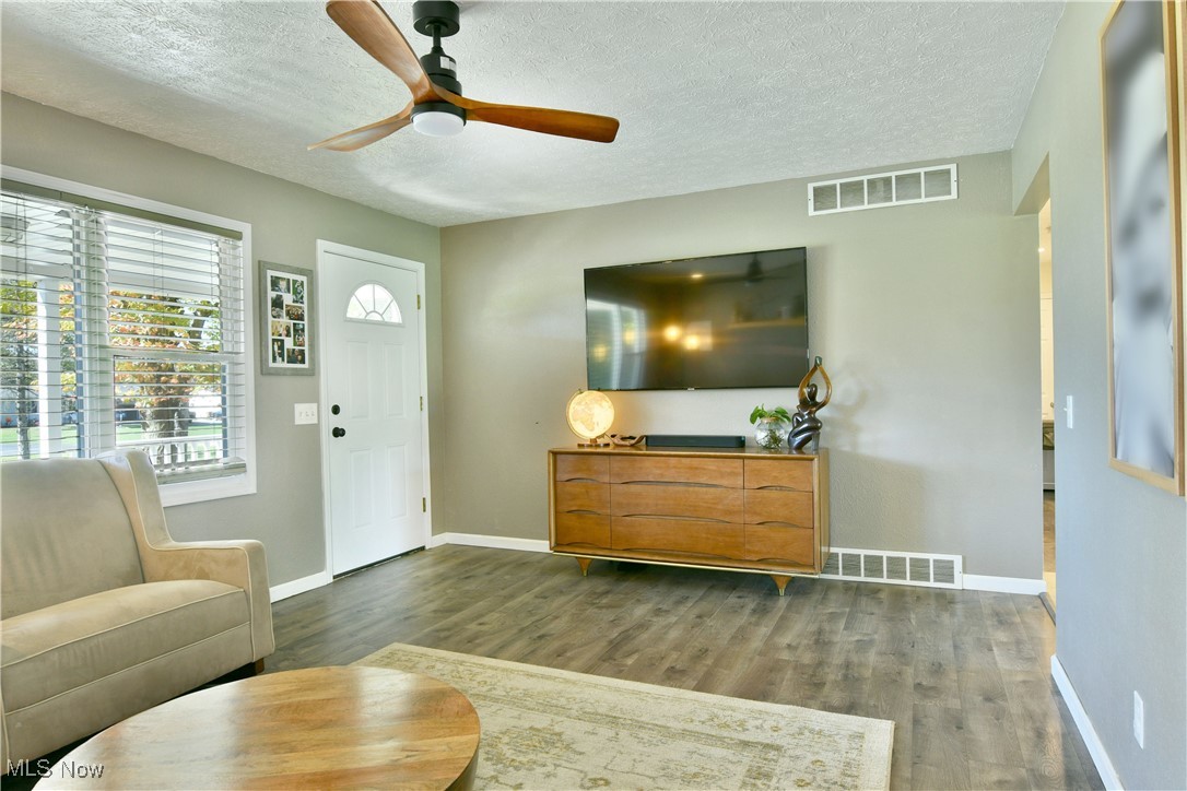 4400 Ridge Road Cortland, OH 44410 - Photo 24 of 50 Living room featuring a textured ceiling, wood finished floors, and ceiling fan