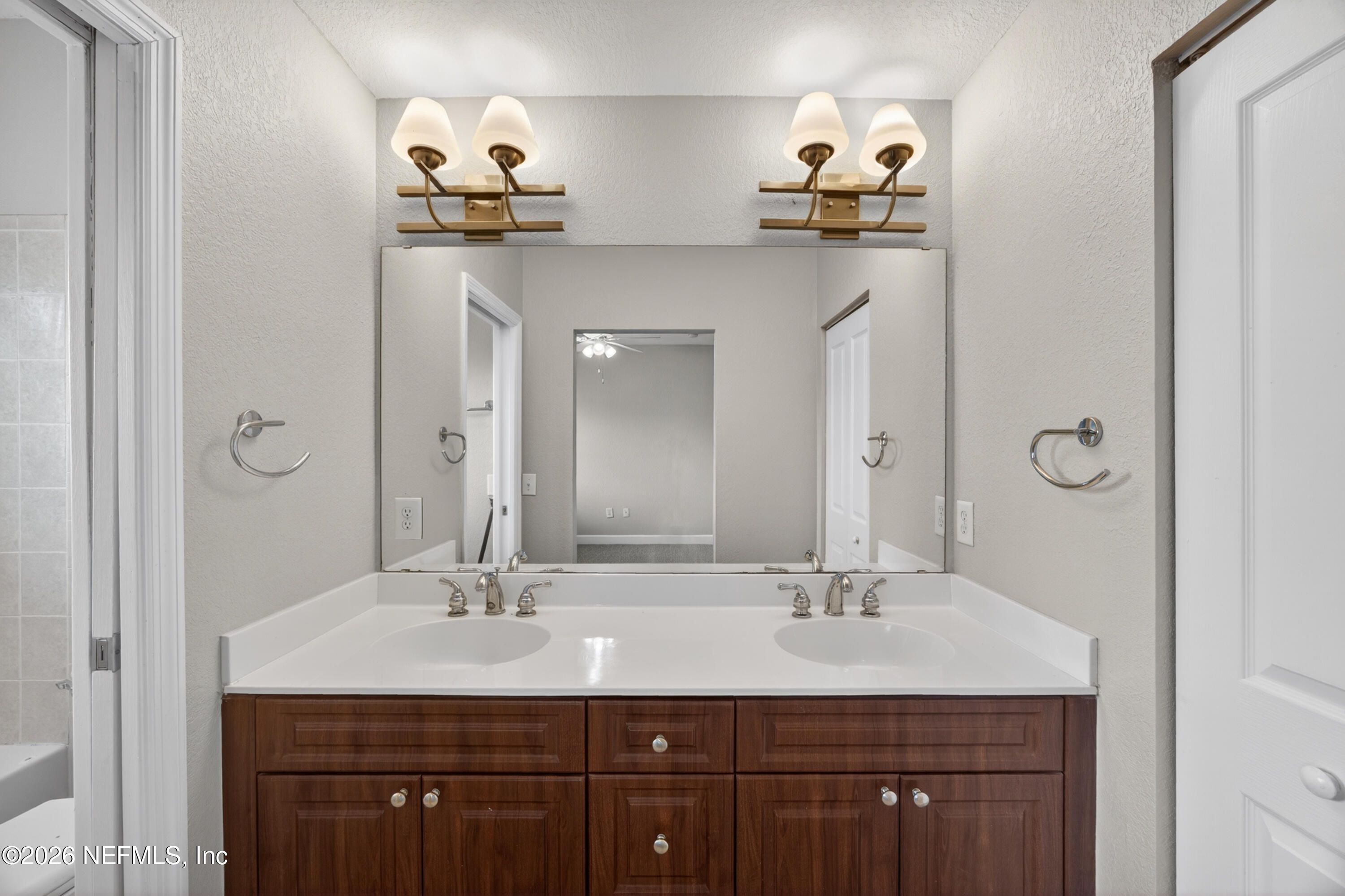 9745 Touchton Road, Unit 1224 Jacksonville, FL 32246 - Photo 14 of 22 a bathroom with double vanity sinks and a mirror