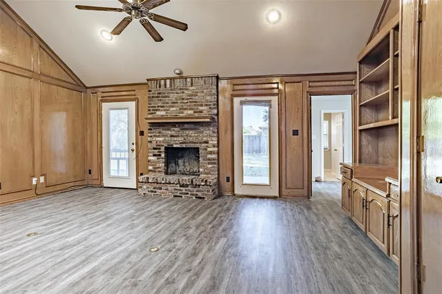 wooden floor in an empty room with a fireplace