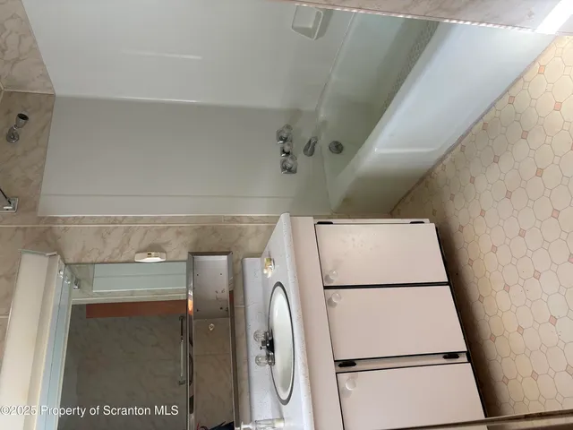 a backyard of a house with plants and large trees