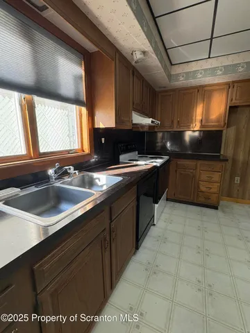 a kitchen with a sink stove and cabinets