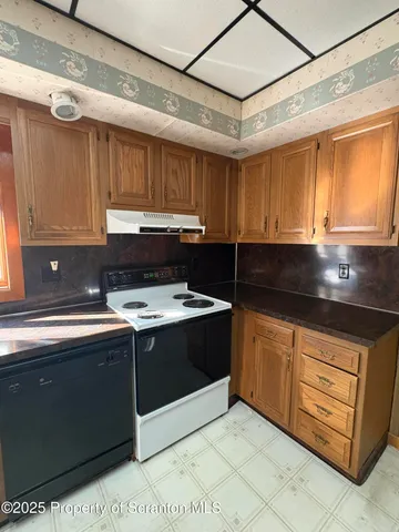a view of a kitchen counter space a sink a window and stainless steel appliances