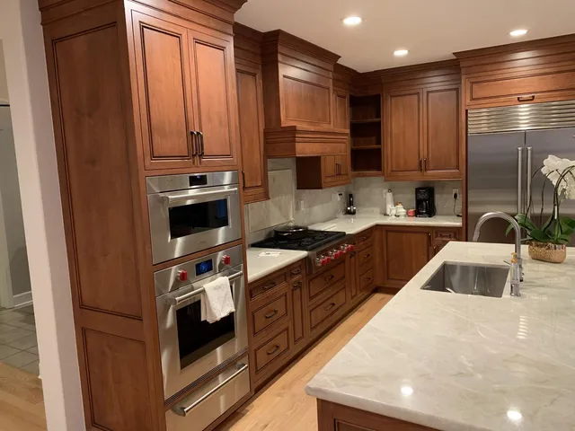 a kitchen with stainless steel appliances a sink stove and refrigerator