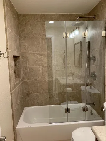 a bathroom with a bathtub and a shower